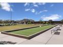 A well-manicured bocce ball court surrounded by lush greenery and comfortable seating in a community setting at 2966 E Bellerive Dr, Gilbert, AZ 85298