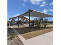 Community playground with shaded play structures, picnic area, and walking paths under a sunny sky at 2966 E Bellerive Dr, Gilbert, AZ 85298