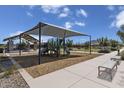 Community playground with shaded play structures, picnic area, and walking paths under a sunny sky at 2966 E Bellerive Dr, Gilbert, AZ 85298