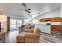 Inviting living room featuring a large window, vaulted ceiling, and seamless flow into the kitchen at 3702 W Megan St, Chandler, AZ 85226