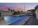 Sparkling private pool in a fenced backyard oasis with lush greenery and desert landscaping at 3702 W Megan St, Chandler, AZ 85226