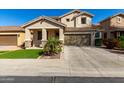 Charming two-story home featuring a well-manicured lawn, desert landscaping, and a two-car garage at 390 W Wisteria Pl, Chandler, AZ 85248