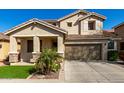 Charming two-story home featuring a well-manicured lawn, desert landscaping, and a two-car garage at 390 W Wisteria Pl, Chandler, AZ 85248
