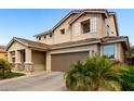 Charming two-story home featuring a well-manicured lawn, desert landscaping, and a two-car garage at 390 W Wisteria Pl, Chandler, AZ 85248