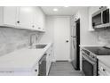 Bright kitchen featuring new stainless steel appliances, white cabinetry, and a modern backsplash at 600 S Dobson Rd # 175, Mesa, AZ 85202
