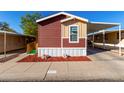 Charming home showcasing unique color combination, landscaping, covered parking, and accessibility ramp at 806 W Summerside Rd, Phoenix, AZ 85041
