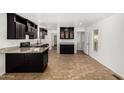 Open kitchen showcasing granite counters, tile floors, ample storage, and stainless-steel appliances at 806 W Summerside Rd, Phoenix, AZ 85041