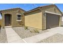 View of the charming home with a two-car garage, desert landscaping, and a covered front entry at 12738 N 172Nd Dr, Surprise, AZ 85388