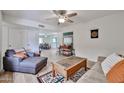 Bright living room with neutral walls, ceiling fan and stylish furnishings, including a coffee table at 12834 W Ashwood Dr, Sun City West, AZ 85375