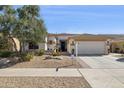 Charming single-story home with desert landscaping, neutral paint, a two-car garage, and a tiled roof at 12873 N 175Th Dr, Surprise, AZ 85388