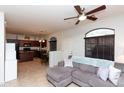 Open concept living room with a ceiling fan and a view of the kitchen and dining area at 1350 S Greenfield Rd # 1016, Mesa, AZ 85206