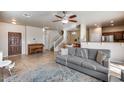 Spacious living room featuring tile floors, a ceiling fan, and an open concept design at 13585 N 87Th Dr, Peoria, AZ 85381