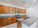 Well-equipped kitchen with granite counters, a central island, and stainless steel appliances at 142 W Atlantic Dr, Casa Grande, AZ 85122