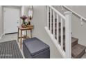 Inviting home entryway featuring staircase, decorative table, and convenient storage bench at 155 N Lakeview Blvd # 206, Chandler, AZ 85225