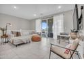 Bright living area showcasing neutral decor, comfortable seating, and outdoor balcony access at 155 N Lakeview Blvd # 206, Chandler, AZ 85225