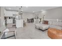 Open-concept living space with stylish furnishings, neutral tones, and tile floors at 155 N Lakeview Blvd # 206, Chandler, AZ 85225