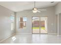 Bright living room featuring tile floors, neutral walls and a sliding glass door to the backyard at 18153 W Fulton St, Goodyear, AZ 85338
