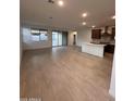 Bright, open-concept living room with tile flooring and access to the backyard through sliding glass doors at 18254 W Vogel Ave, Goodyear, AZ 85338