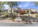 Beautiful single-story home with a circular turret, desert landscaping, and a stone walkway at 19494 N 98Th Pl, Scottsdale, AZ 85255