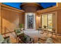 Private front courtyard with ample seating featuring decorative pavers, and an iron security door at 26648 W Quail Ave, Buckeye, AZ 85396