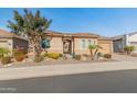 Charming home featuring a tiled roof, two-car garage, desert landscaping, and an arched entryway at 26648 W Quail Ave, Buckeye, AZ 85396