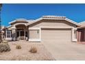 Well-maintained single-story home featuring a two-car garage and attractive desert landscaping at 4102 E Cathedral Rock Dr, Phoenix, AZ 85044