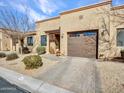 Beautiful exterior view showcasing the home's facade, lush landscaping, and an inviting brick driveway, perfect for curb appeal at 4241 N Pebble Creek Pkwy # 42, Goodyear, AZ 85395