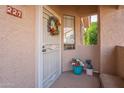 Inviting home entrance with a decorated security door, potted plants, and exterior window for natural light at 5450 E Mclellan Rd # G227, Mesa, AZ 85205