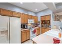 Functional kitchen with classic wood cabinets, white appliances, and durable countertops for everyday convenience at 5450 E Mclellan Rd # G227, Mesa, AZ 85205