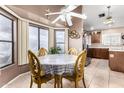 Bright dining nook featuring large windows and a ceiling fan at 9014 E Sharon Dr, Scottsdale, AZ 85260