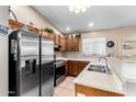 Well-lit kitchen featuring stainless steel appliances, wooden cabinetry, and spacious countertops at 9014 E Sharon Dr, Scottsdale, AZ 85260