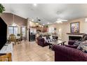 Cozy living area featuring tile flooring, fireplace, and open access to the kitchen at 9014 E Sharon Dr, Scottsdale, AZ 85260