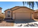 Inviting single-story home featuring a well-maintained exterior, tile roof and a two-car garage at 911 E Lovegrass Dr, San Tan Valley, AZ 85143