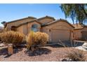 Attractive one-story home with a tile roof and a two-car garage with desert landscaping at 911 E Lovegrass Dr, San Tan Valley, AZ 85143