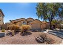 Well-maintained home with neutral color palette, tile roof, low maintenance landscaping, and an attached garage at 911 E Lovegrass Dr, San Tan Valley, AZ 85143