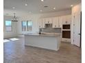 Open-concept kitchen features a large island, modern appliances, and ample counter space at 10027 W Verde Ln, Avondale, AZ 85392