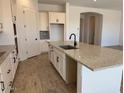 Spacious kitchen island with granite countertop and stainless steel sink at 10027 W Verde Ln, Avondale, AZ 85392