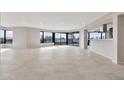 Open living space with sleek tile, a wall of windows, and a convenient pass-through to the kitchen at 1040 E Osborn Rd # 404, Phoenix, AZ 85014