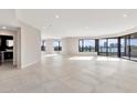Expansive living room features sleek tile flooring, recessed lighting, and large windows with city views at 1040 E Osborn Rd # 404, Phoenix, AZ 85014