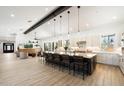 Spacious kitchen features an oversized kitchen island with seating and open floor plan into living area at 11212 N Miller Rd, Scottsdale, AZ 85260