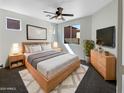 Cozy main bedroom boasts a comfortable bed, stylish furniture, and a serene atmosphere with neutral tones at 1131 E Catino St, San Tan Valley, AZ 85140