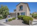Inviting two-story home with lush landscaping, a desert rock yard, and a welcoming entryway at 1236 E Mescal St, Phoenix, AZ 85020