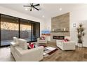 Inviting living room featuring comfortable seating, a stylish fireplace, and large sliding doors to the patio at 14715 N Adero Canyon Dr, Fountain Hills, AZ 85268