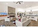 Bright, open-concept living area with tile floors, a modern fireplace, and sleek white furniture at 14715 N Adero Canyon Dr, Fountain Hills, AZ 85268