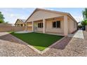 Enjoy outdoor living with a covered patio and low-maintenance artificial grass at 14994 W Charter Oak Rd, Surprise, AZ 85379