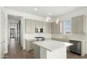 Well-lit kitchen featuring a center island, stainless steel appliances, modern fixtures, and beautiful backsplash at 15720 S 182Nd Ave, Goodyear, AZ 85338