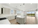 Bright, open-concept kitchen with center island, stainless steel appliances, tile floors and access to backyard at 15720 S 182Nd Ave, Goodyear, AZ 85338