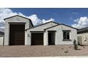 Charming single-story home featuring a three-car garage, neutral stucco exterior, and desert landscaping for modern appeal at 15782 W Cheryl Dr, Waddell, AZ 85355