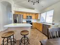Bright kitchen featuring stainless steel appliances, light wood cabinets, and an island with bar seating at 1771 E Erie St, Gilbert, AZ 85295