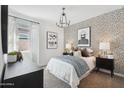 Charming bedroom with patterned wallpaper, elegant decor, a stylish chandelier, and bright natural light at 18875 E Bruno Dr, Gold Canyon, AZ 85118